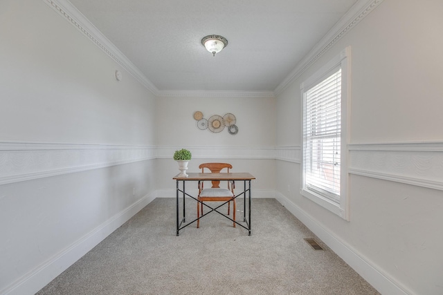 home office with light carpet, ornamental molding, and a healthy amount of sunlight