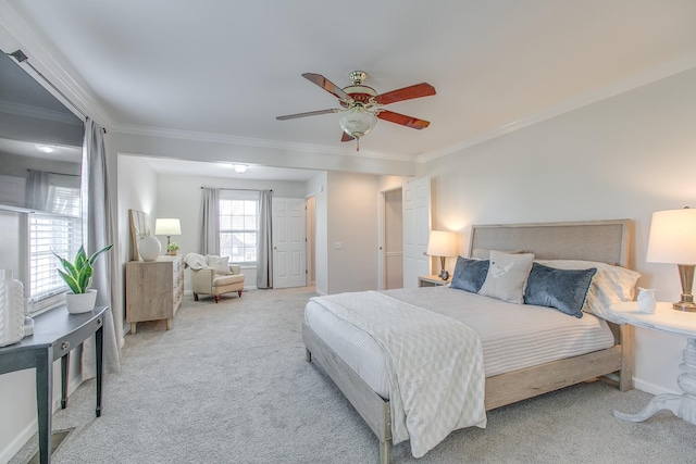 carpeted bedroom featuring ceiling fan and ornamental molding