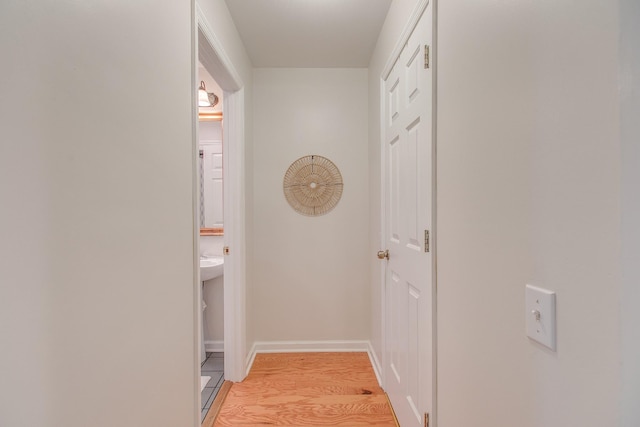 corridor with light wood-type flooring