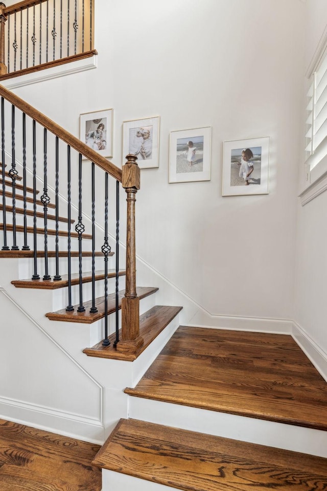 stairs featuring hardwood / wood-style flooring