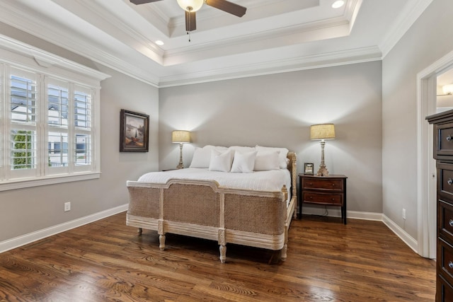 bedroom featuring a raised ceiling, ceiling fan, dark hardwood / wood-style flooring, and crown molding