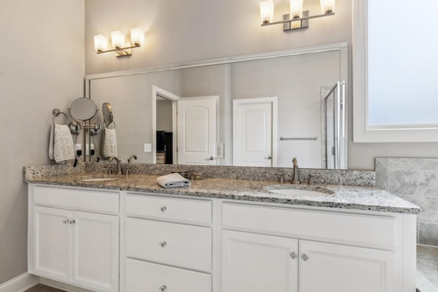 bathroom featuring vanity and a shower with shower door