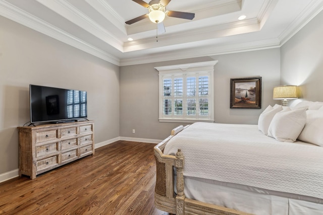 bedroom with a raised ceiling, ceiling fan, dark hardwood / wood-style flooring, and crown molding