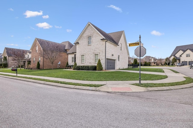 view of front of house with a garage and a front lawn