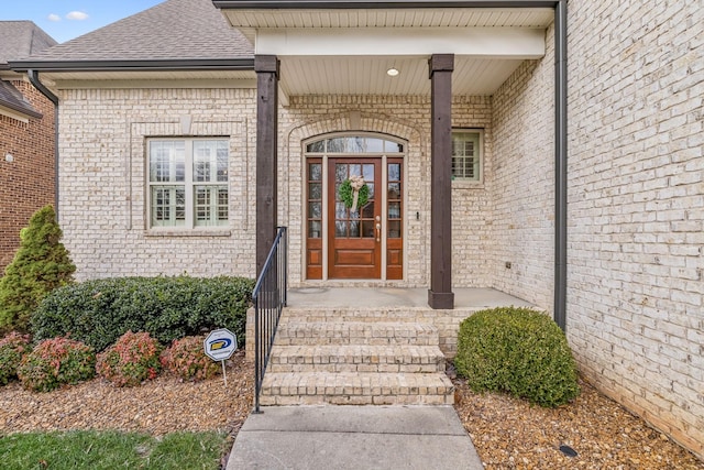 view of exterior entry featuring a porch