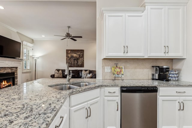 kitchen featuring stainless steel dishwasher, white cabinets, and sink