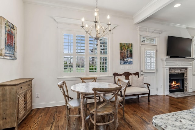 dining room featuring a stone fireplace, dark hardwood / wood-style floors, ornamental molding, a notable chandelier, and beam ceiling