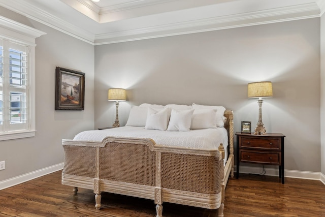 bedroom featuring a raised ceiling, crown molding, and dark hardwood / wood-style floors