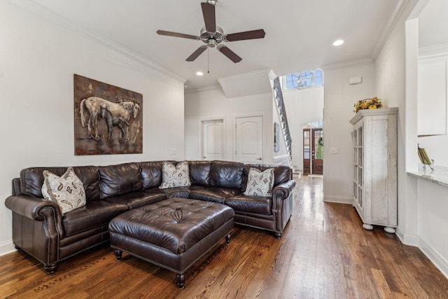 living room with crown molding, ceiling fan, and dark hardwood / wood-style floors