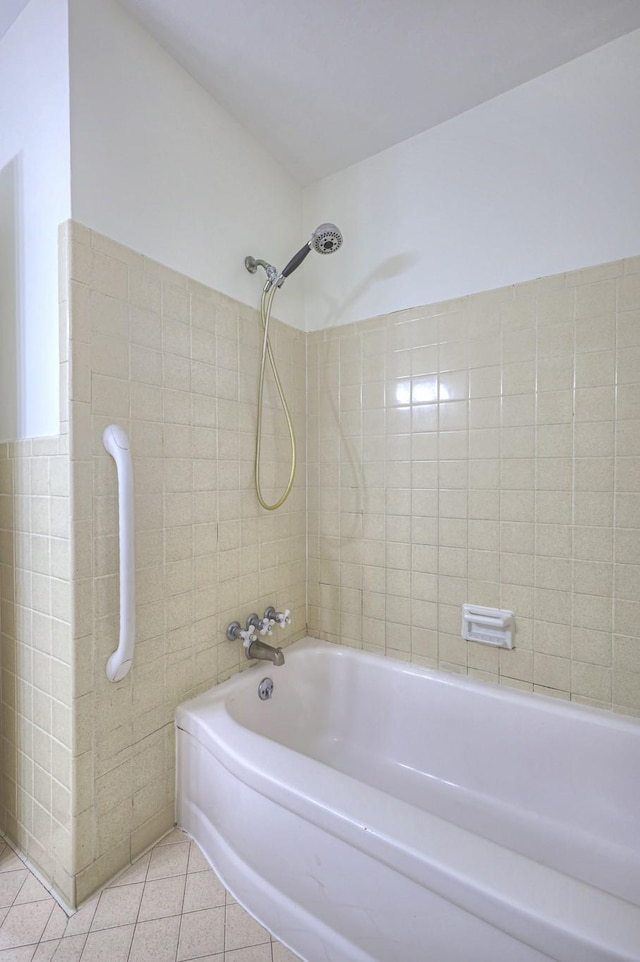 full bathroom featuring shower / tub combination, tile patterned flooring, and tile walls