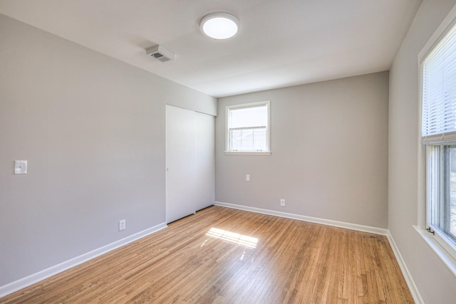 empty room featuring light wood-style flooring and baseboards