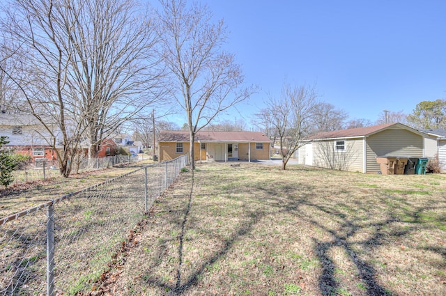 view of front of home with a front yard, fence private yard, and an outdoor structure