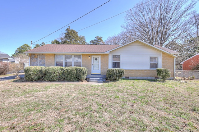 single story home with brick siding, fence, and a front lawn