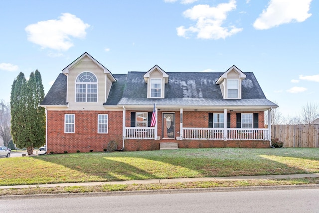 cape cod house with covered porch and a front lawn