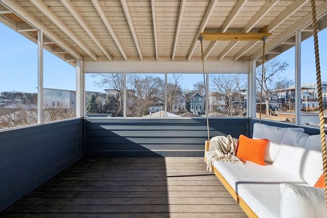 unfurnished sunroom featuring beamed ceiling and wood ceiling