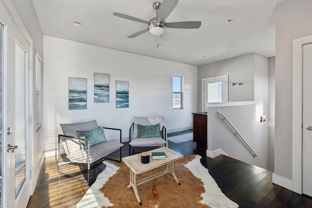 living area with dark hardwood / wood-style floors and ceiling fan