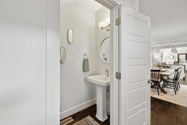 bathroom with hardwood / wood-style floors