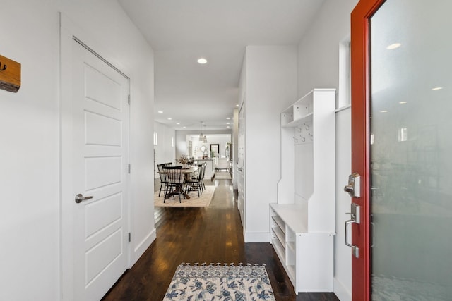 hallway with dark hardwood / wood-style flooring