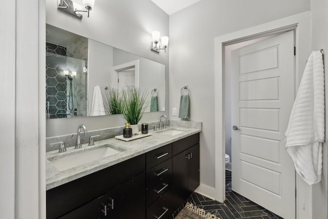 bathroom featuring tile patterned floors, vanity, toilet, and a shower with door