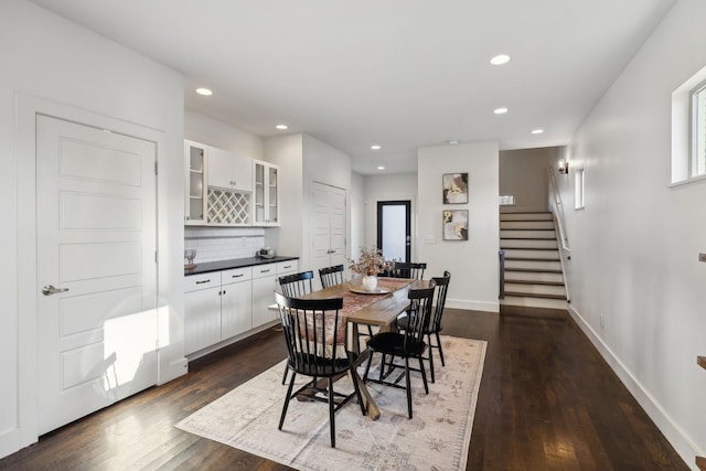 dining space with dark hardwood / wood-style floors and indoor bar