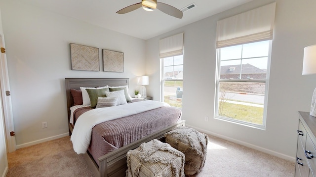 bedroom featuring ceiling fan and light carpet