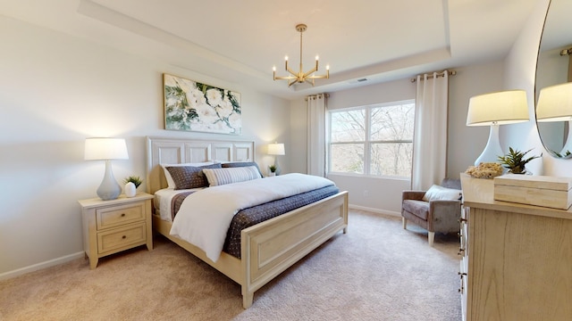 bedroom with a raised ceiling, light colored carpet, and a notable chandelier