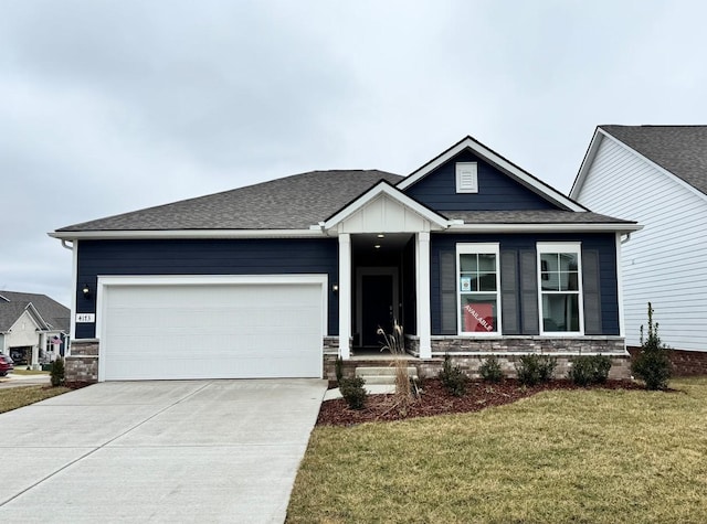 view of front of home with a garage and a front yard