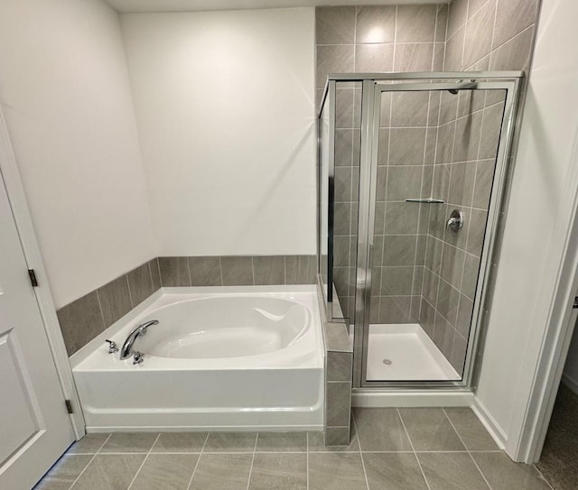 bathroom with separate shower and tub and tile patterned floors