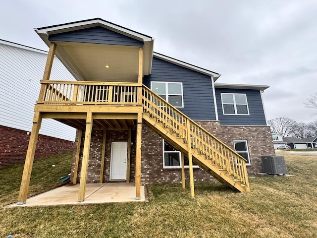 back of house featuring a patio, a yard, central AC, and a deck