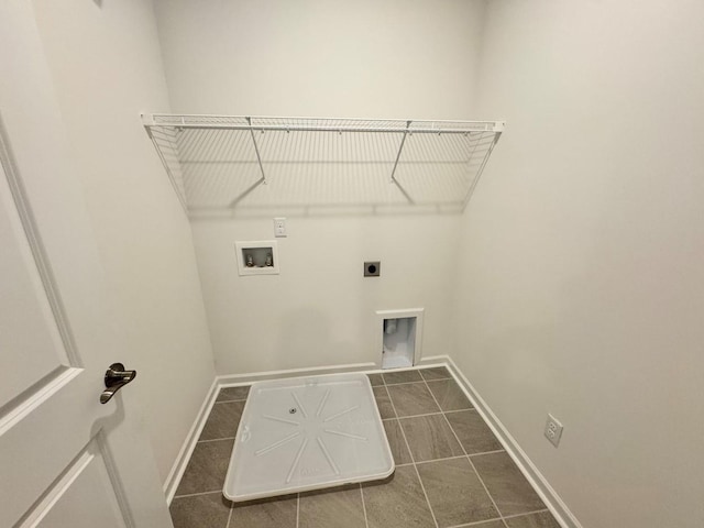 laundry area featuring washer hookup, hookup for an electric dryer, and dark tile patterned flooring