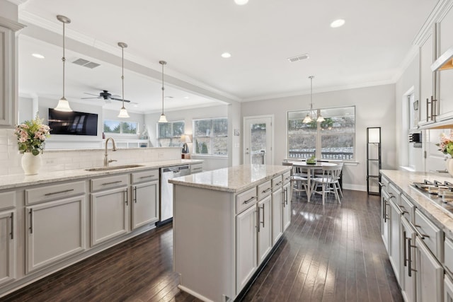 kitchen with dishwasher, backsplash, decorative light fixtures, and sink