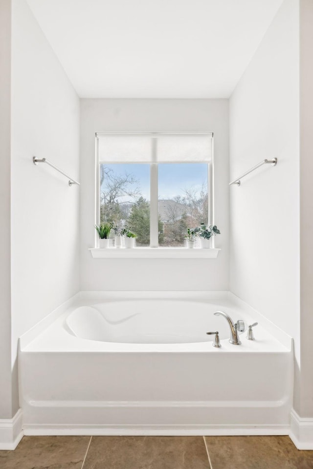 bathroom featuring tile patterned flooring and a bath