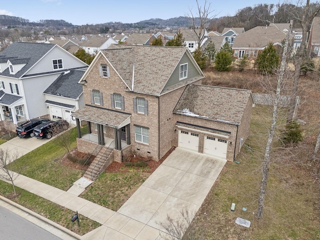 view of front facade with a porch, a garage, and a front lawn