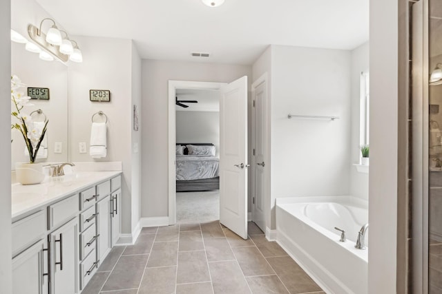 bathroom featuring tile patterned floors, vanity, ceiling fan, and a bath