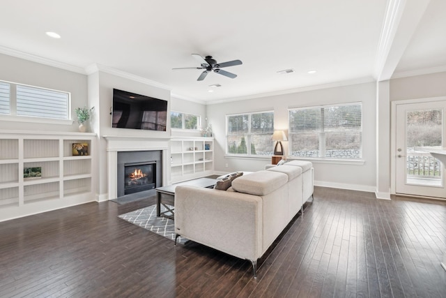 living room with dark hardwood / wood-style floors, ceiling fan, and crown molding