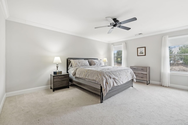 carpeted bedroom featuring ceiling fan and crown molding