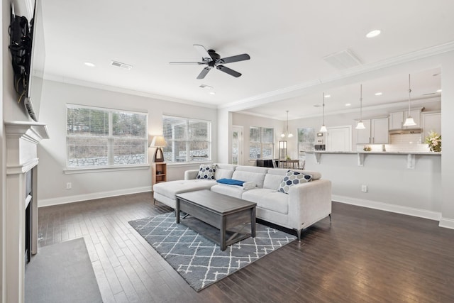 living room with ceiling fan, dark wood-type flooring, and ornamental molding