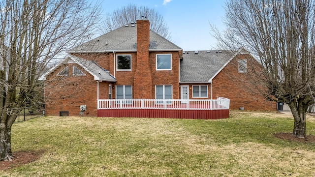 back of house featuring a lawn and a deck