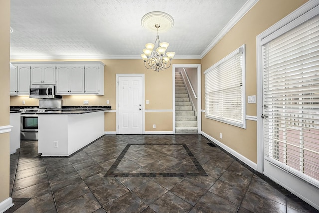 kitchen featuring kitchen peninsula, appliances with stainless steel finishes, crown molding, white cabinets, and hanging light fixtures