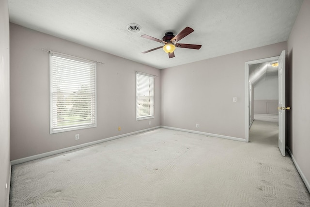 unfurnished bedroom with ceiling fan and light carpet