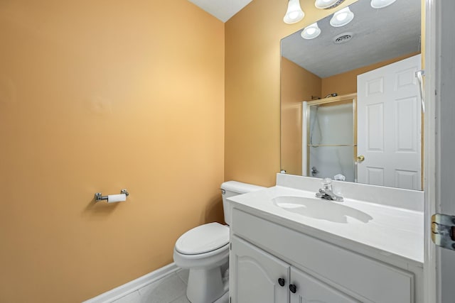 bathroom with toilet, vanity, tile patterned floors, and a shower with shower door