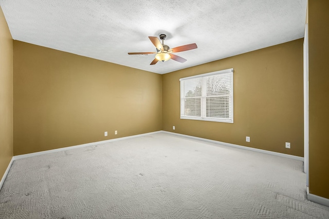 empty room with light carpet and a textured ceiling