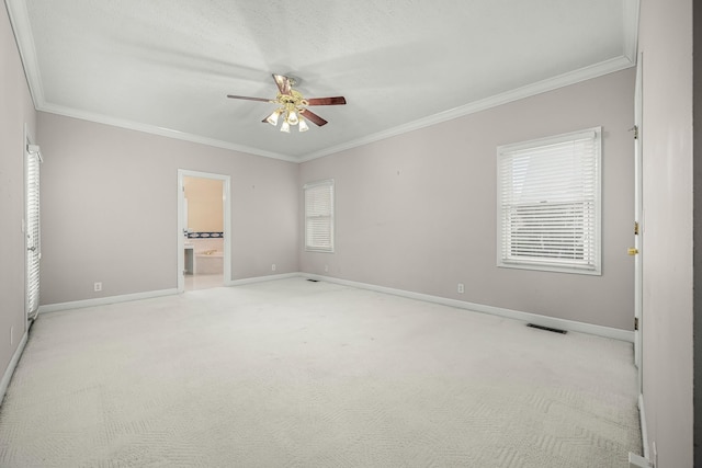 interior space with crown molding, ceiling fan, and light colored carpet