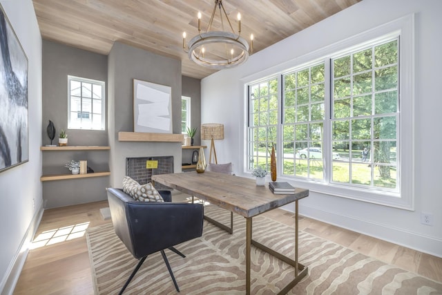 home office featuring a chandelier, light hardwood / wood-style flooring, and wooden ceiling