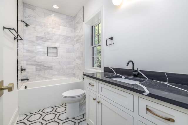 full bathroom featuring tile patterned floors, vanity, toilet, and tiled shower / bath