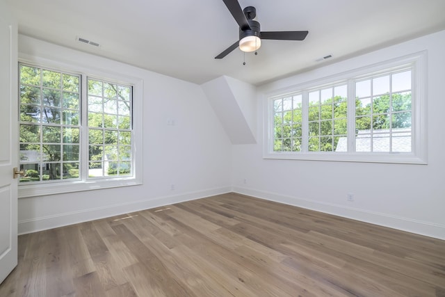 additional living space with hardwood / wood-style flooring and ceiling fan