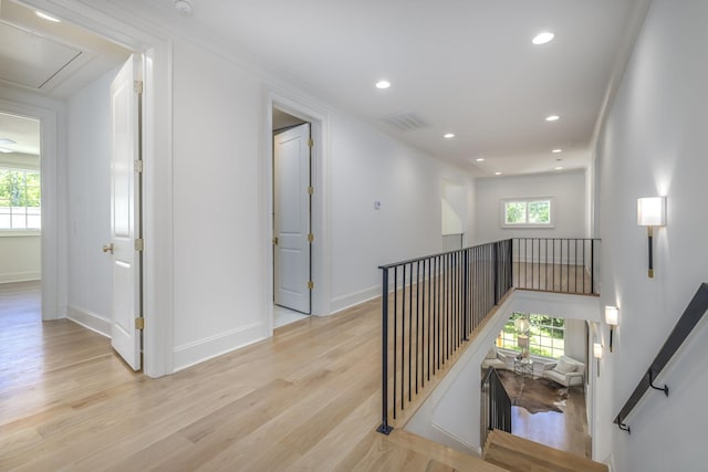 corridor featuring light hardwood / wood-style flooring and ornamental molding