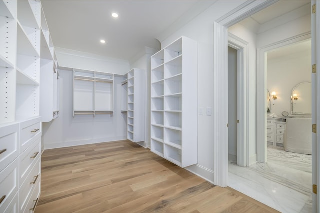 walk in closet featuring light hardwood / wood-style flooring