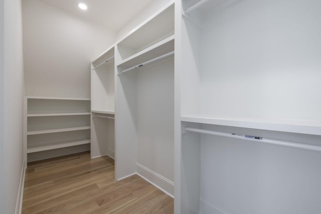 walk in closet featuring light hardwood / wood-style flooring