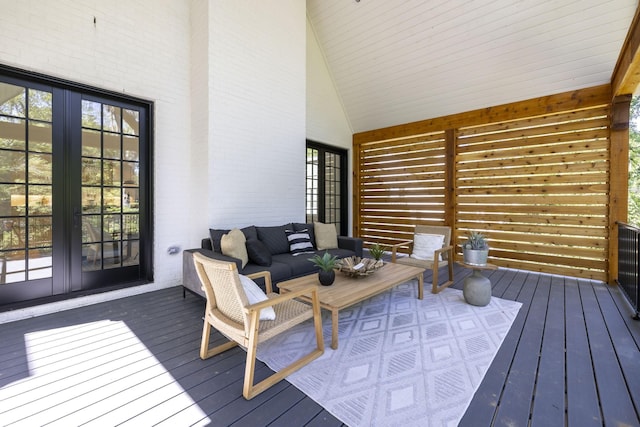 wooden deck featuring outdoor lounge area and french doors